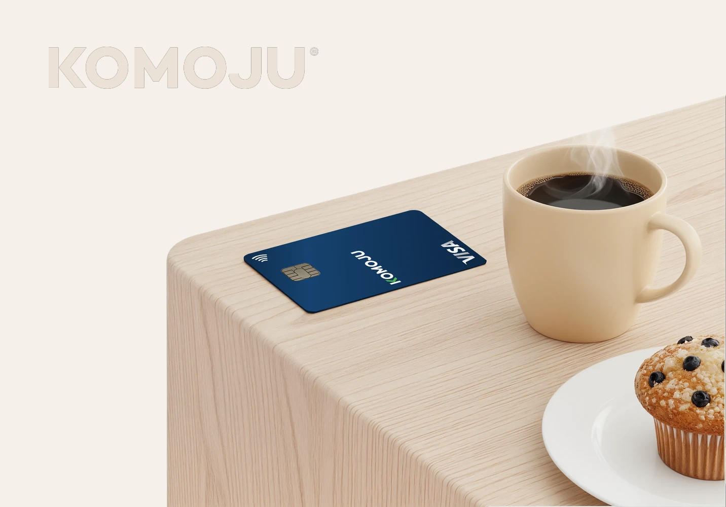 KOMOJU card and coffee on a desk
