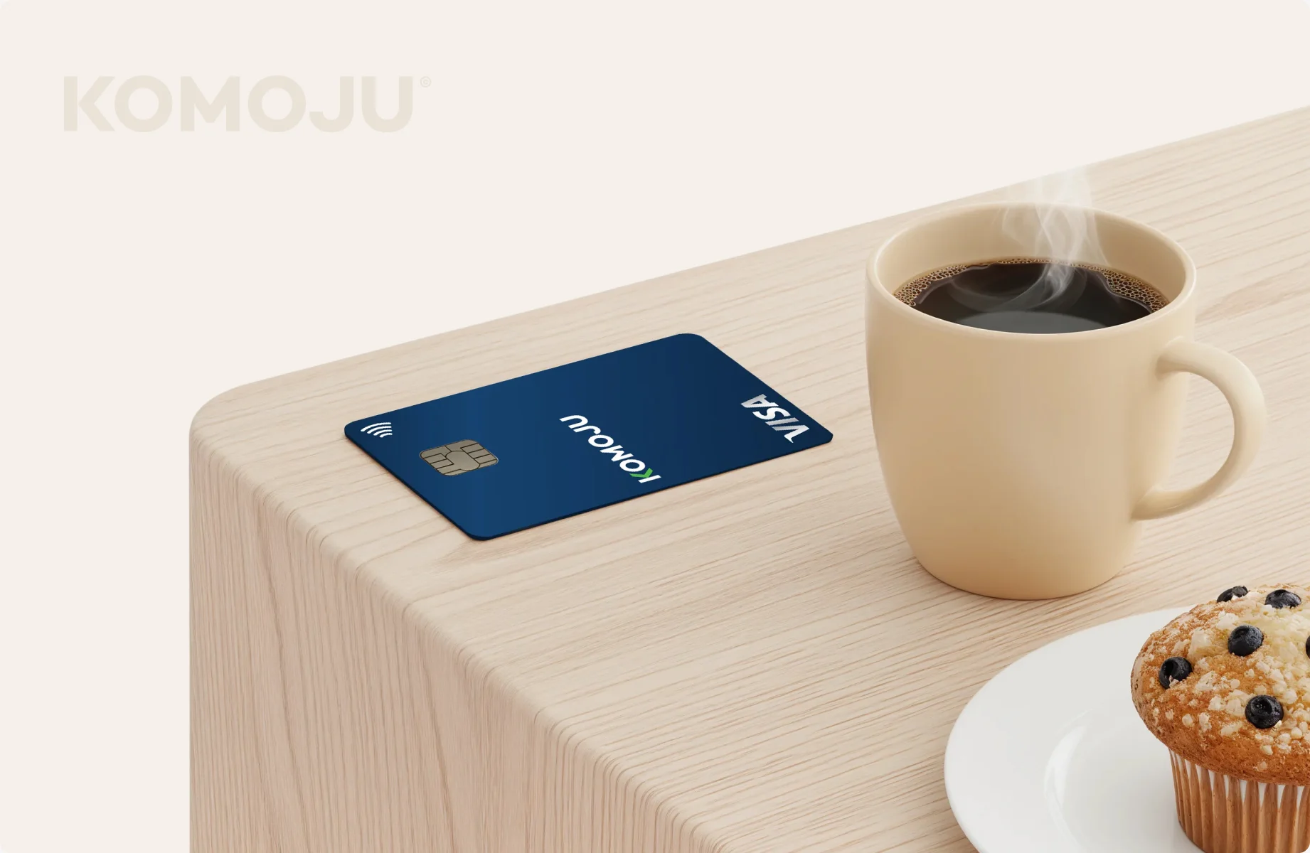 KOMOJU card and coffee on a desk