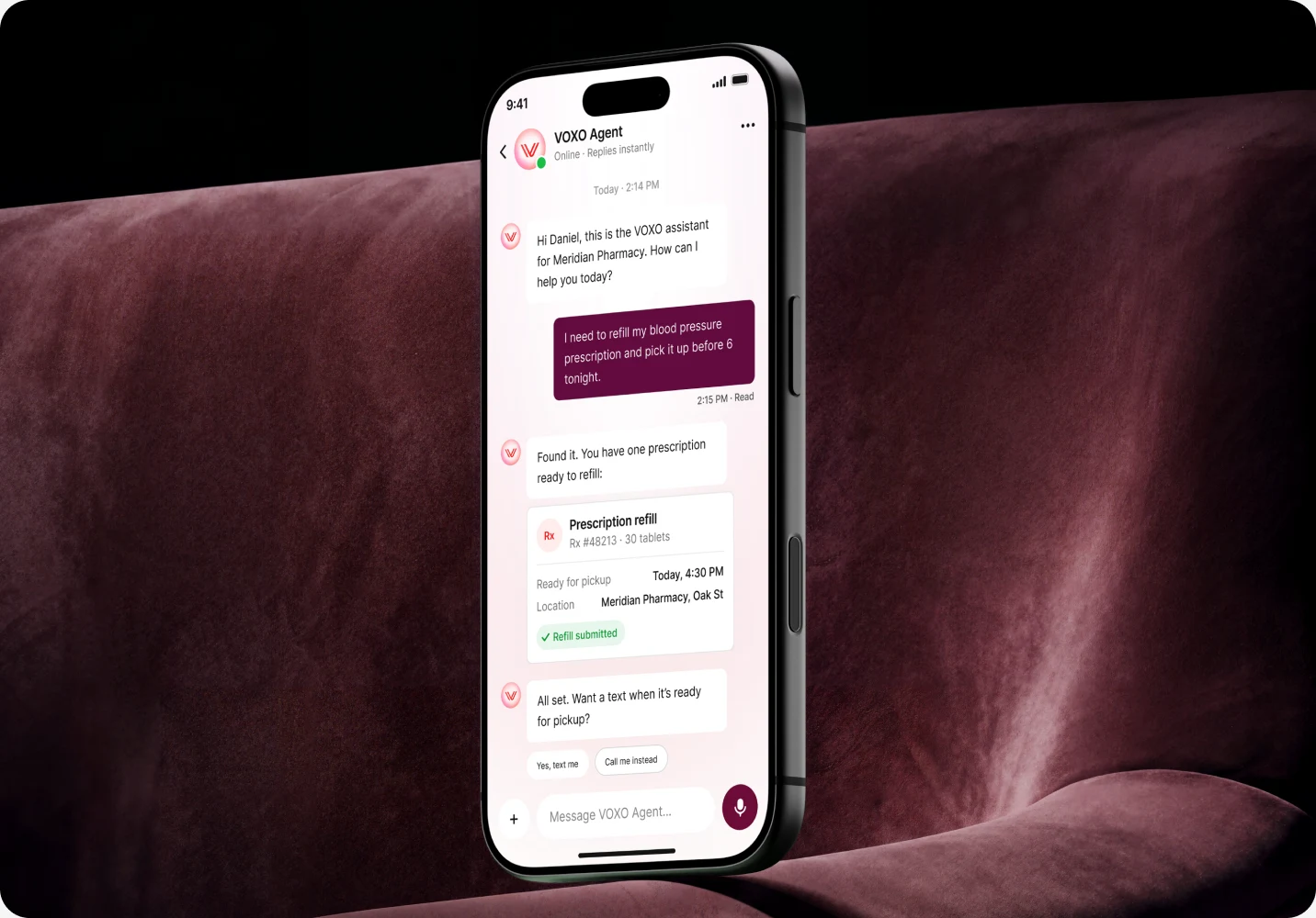 VOXO messaging on a phone resting on a velvet couch