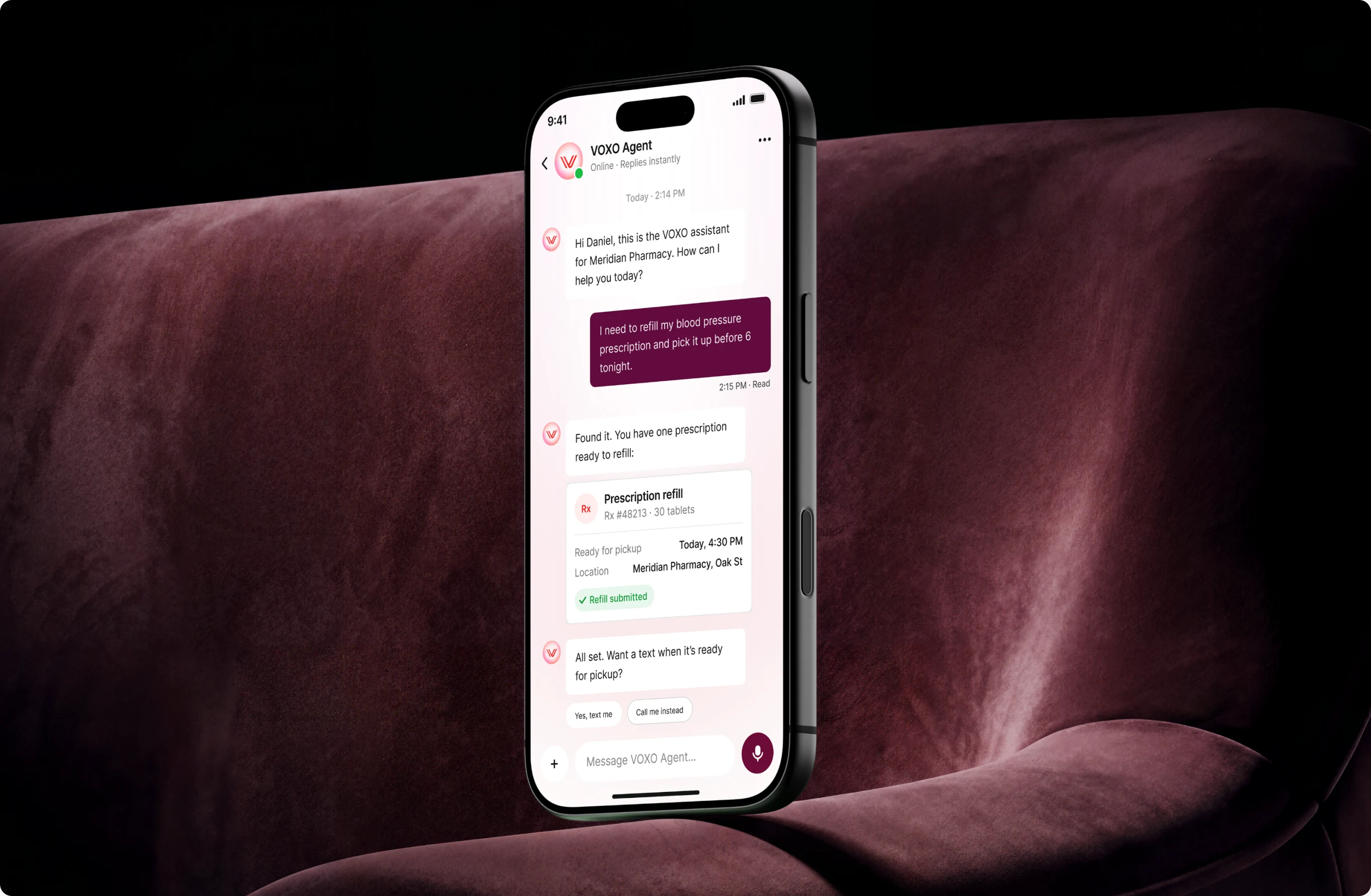 VOXO messaging on a phone resting on a velvet couch